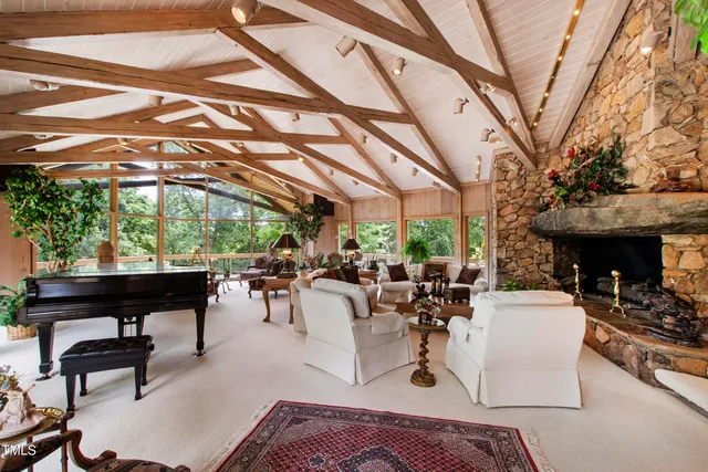 an aerial view of residential house with outdoor space and trees all around