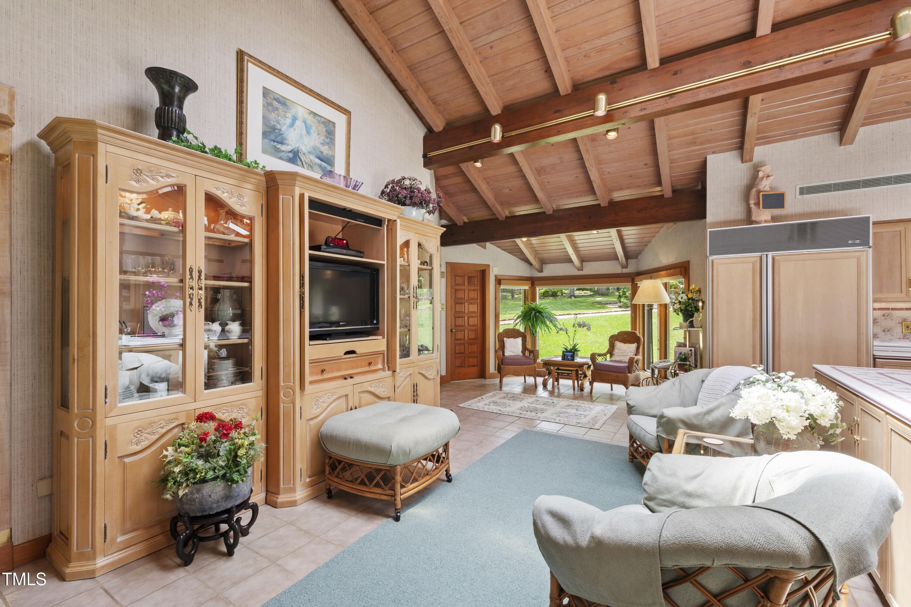 812 Kenmore Road Chapel Hill, NC 27514 - Photo 65 of 95 a living room with furniture a flat screen tv and a large window