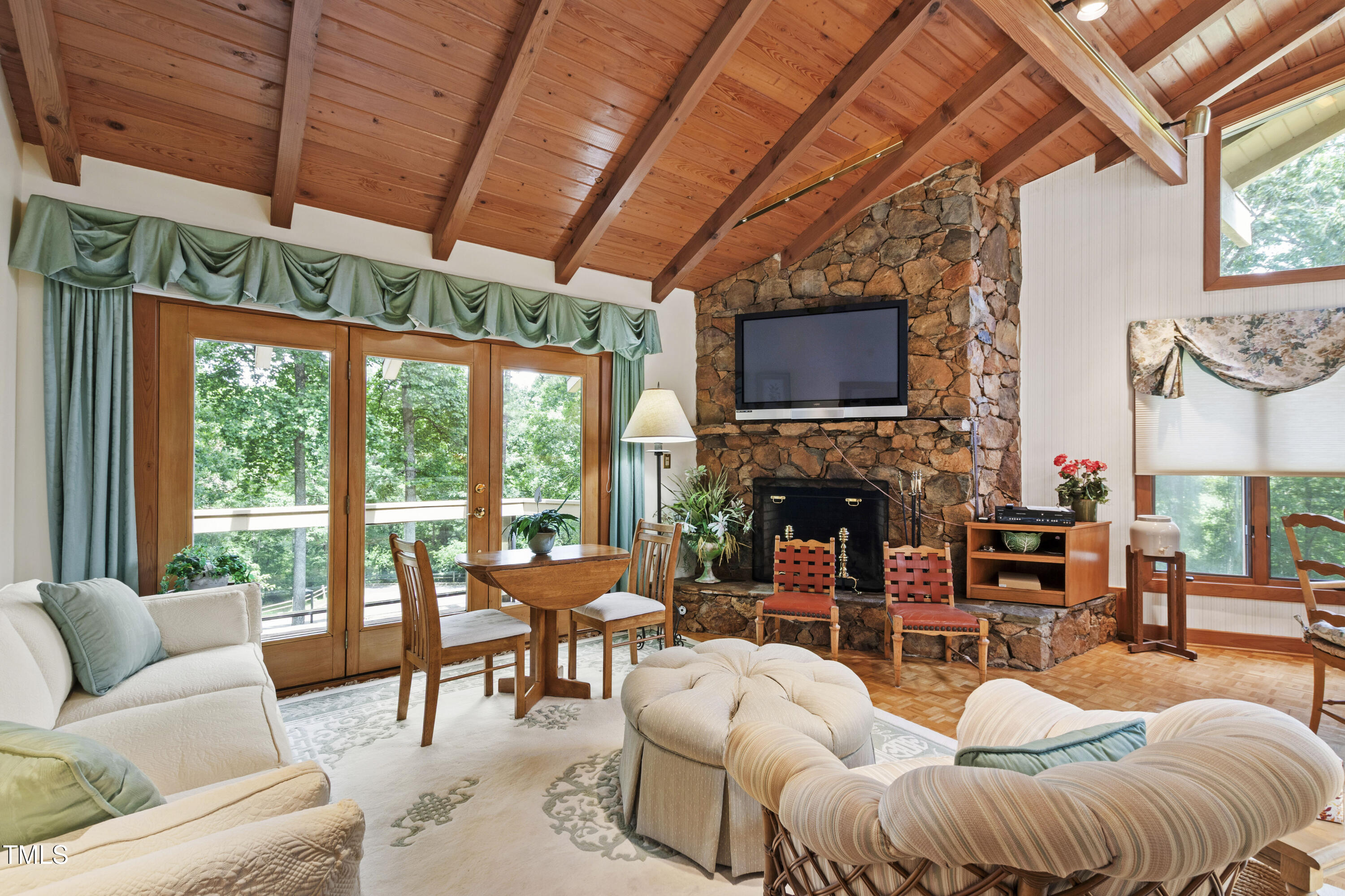 812 Kenmore Road Chapel Hill, NC 27514 - Photo 79 of 95 a living room with furniture a fireplace and a flat screen tv