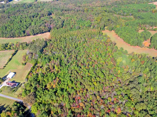 an aerial view of house with yard and ocean view