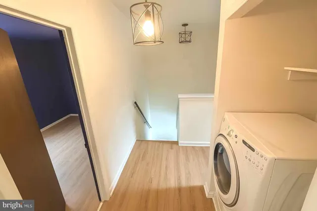 a view of a storage and utility room with washer and dryer
