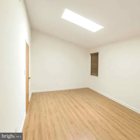 a view of an empty room and wooden floor