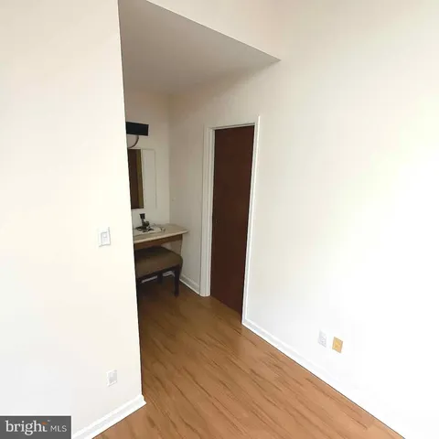 a view of a room with wooden floor