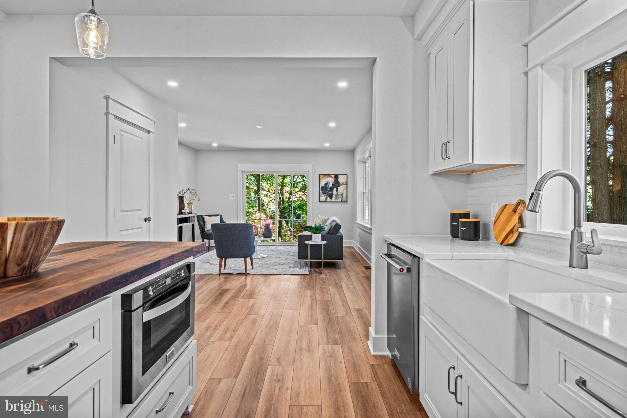 406 St Davids Avenue Wayne, PA 19087 - Photo 15 of 53 a kitchen with a sink dishwasher a stove and white cabinets with wooden floor