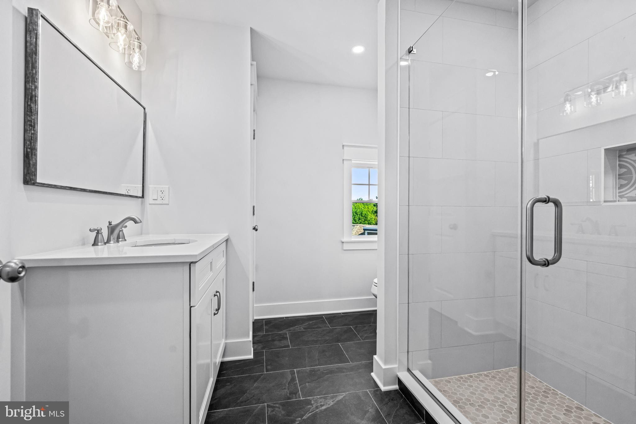 406 St Davids Avenue Wayne, PA 19087 - Photo 47 of 53 a bathroom with a shower sink and mirror