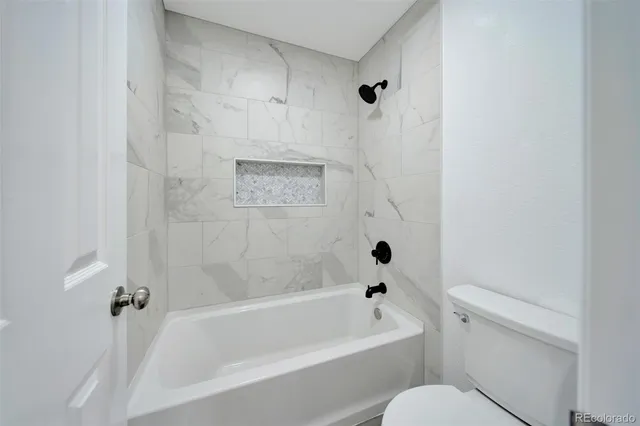 a bathroom with a double vanity sink mirror and bathtub