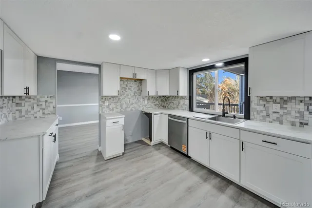 a kitchen with white cabinets and white appliances