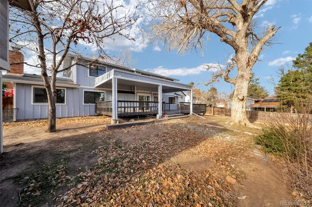 a backyard of a house with fire pit and couches