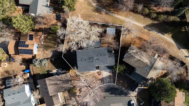 an aerial view of a house with a yard