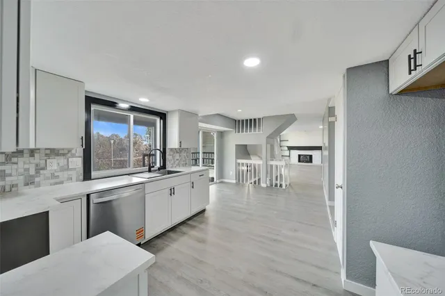 a large kitchen with a stove top oven sink and cabinets