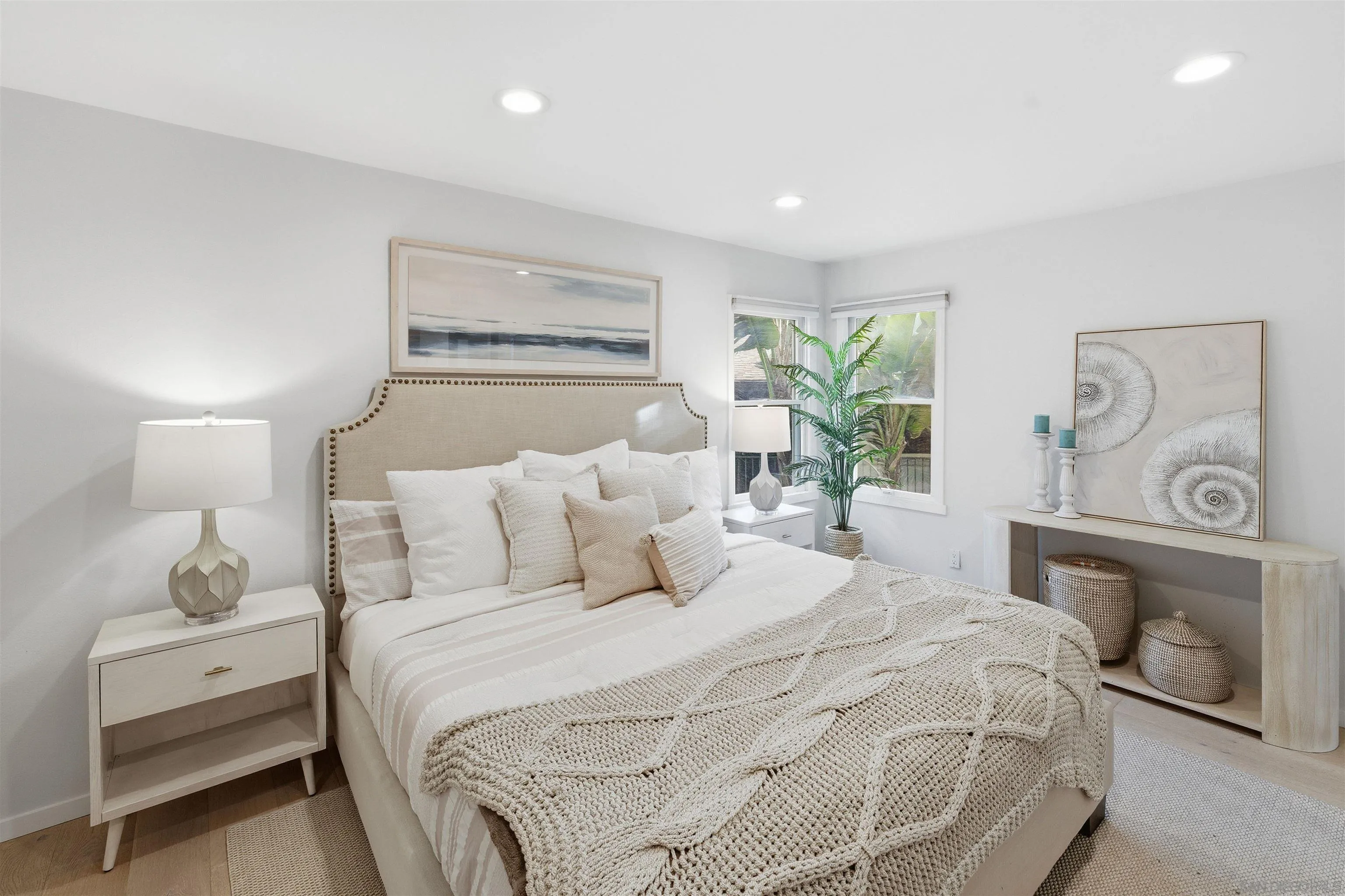 940 Sealane Drive, Unit 5 Encinitas, CA 92024 - Photo 11 of 48 a bedroom with a large bed and a chandelier