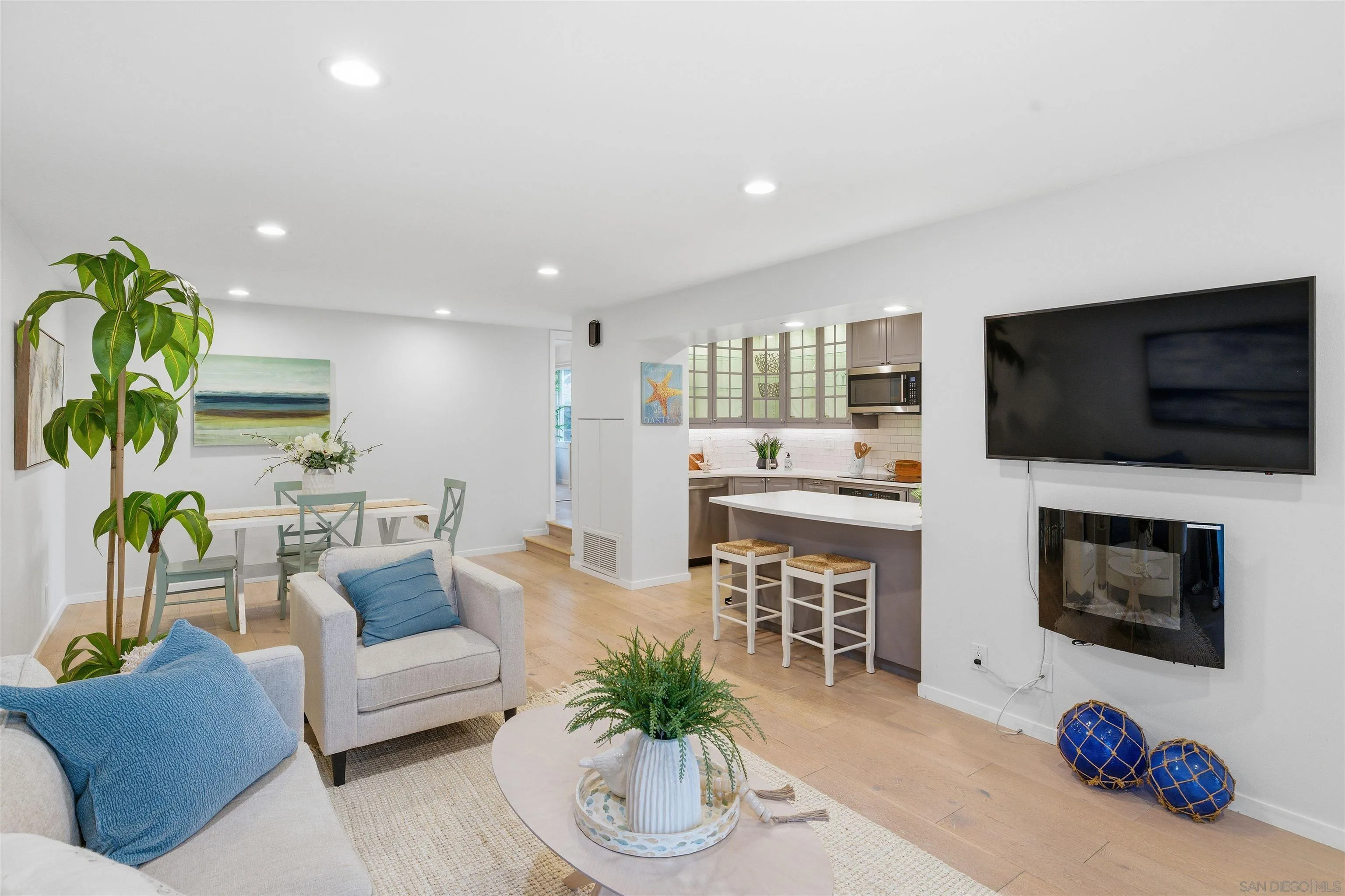940 Sealane Drive, Unit 5 Encinitas, CA 92024 - Photo 2 of 48 a living room with furniture a flat screen tv and a fireplace