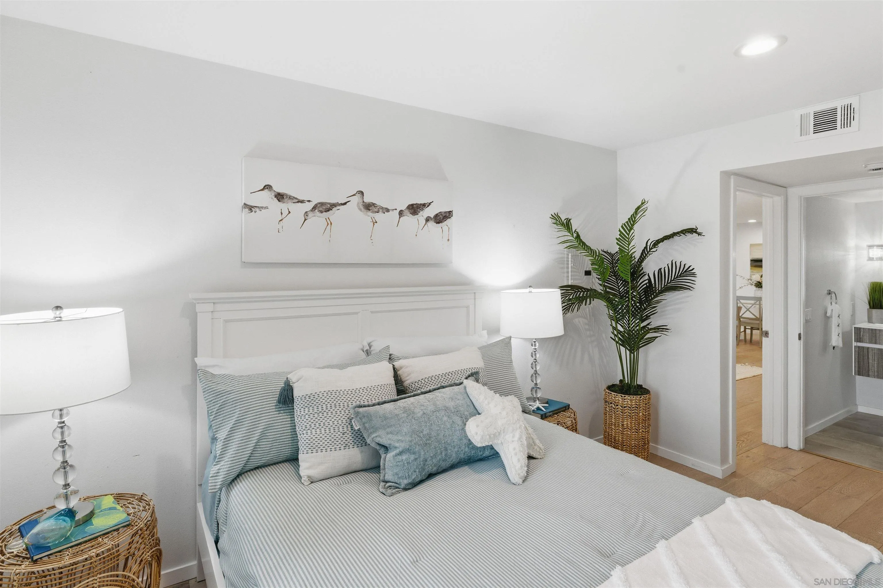 940 Sealane Drive, Unit 5 Encinitas, CA 92024 - Photo 9 of 48 a bedroom with a bed and a potted plant