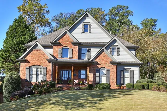a front view of a house with a yard