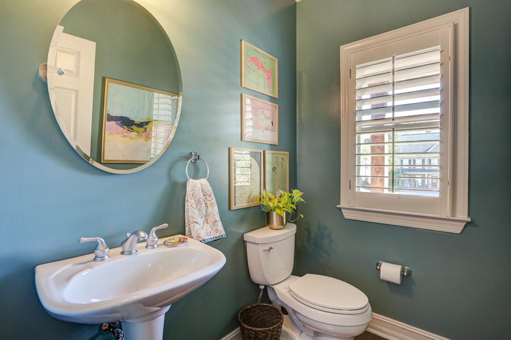 3805 Pennington Road Cumming, GA 30041 - Photo 11 of 63 a bathroom with a toilet a sink and a mirror