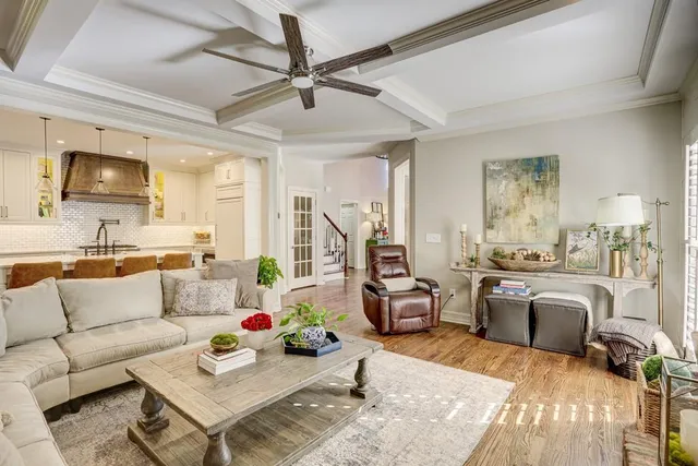 a kitchen with stainless steel appliances granite countertop a sink a stove a refrigerator cabinets and chairs