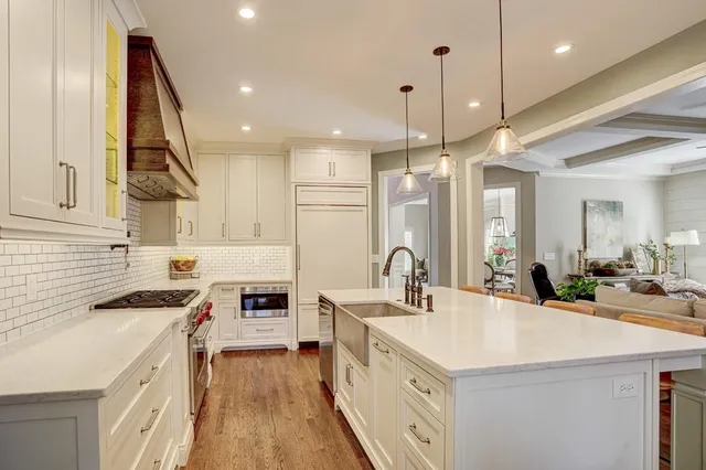 a dining room with furniture a chandelier and wooden floor
