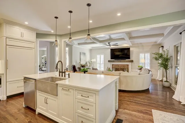 a kitchen with a table chairs stove and wooden floor