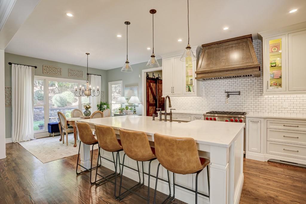 3805 Pennington Road Cumming, GA 30041 - Photo 25 of 63 a kitchen with stainless steel appliances granite countertop a stove a refrigerator a oven a sink with a dining table and chairs