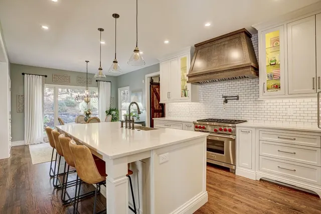 a living room with furniture and a large window with garden view