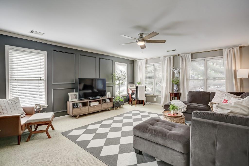 3805 Pennington Road Cumming, GA 30041 - Photo 41 of 63 a living room with furniture and a flat screen tv