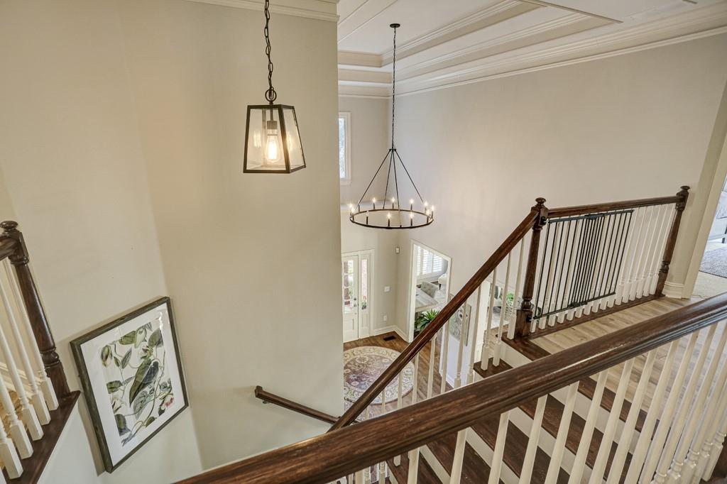 3805 Pennington Road Cumming, GA 30041 - Photo 44 of 63 a view of staircase with lots of frames on wall and a window