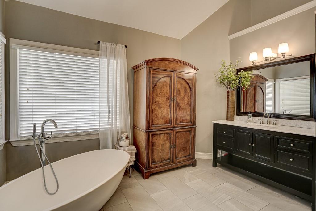 3805 Pennington Road Cumming, GA 30041 - Photo 48 of 63 a bathroom with a tub a sink and mirrors