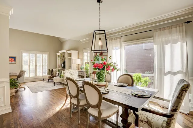 a living room with furniture fireplace and potted plants
