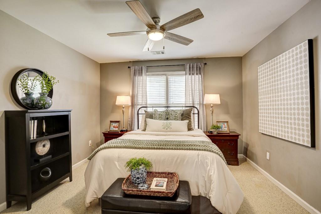 3805 Pennington Road Cumming, GA 30041 - Photo 54 of 63 a bedroom with a bed and a chandelier