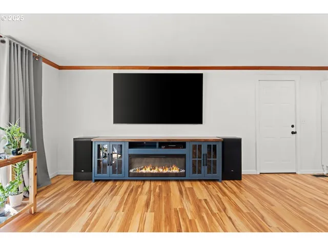 a living room with a flat screen tv and fireplace