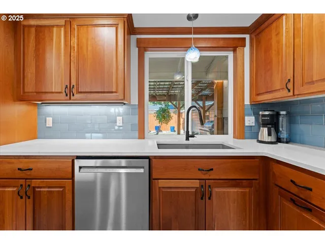 a kitchen with stainless steel appliances granite countertop a sink and cabinets