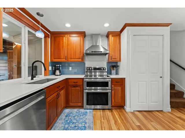 a kitchen with stainless steel appliances a stove sink and cabinets