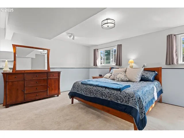 a bedroom with a bed and a dresser