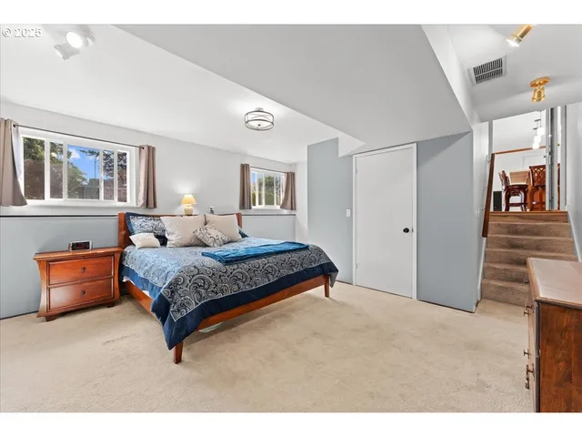 a bedroom with a bed and a painting on the wall