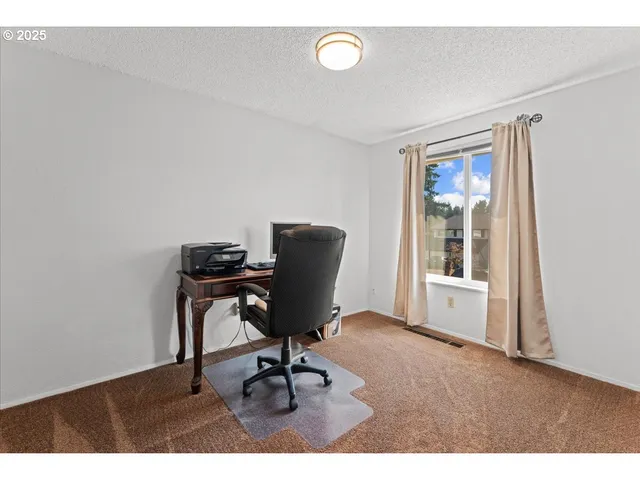 a view of workspace with wooden floor windows