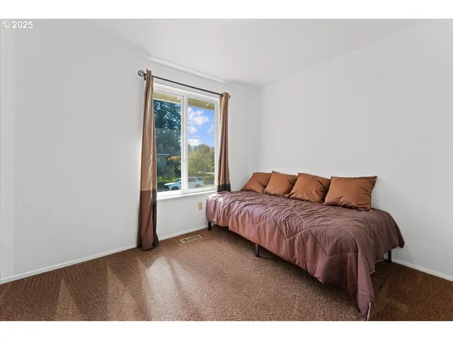 a bedroom with a large bed and a large window