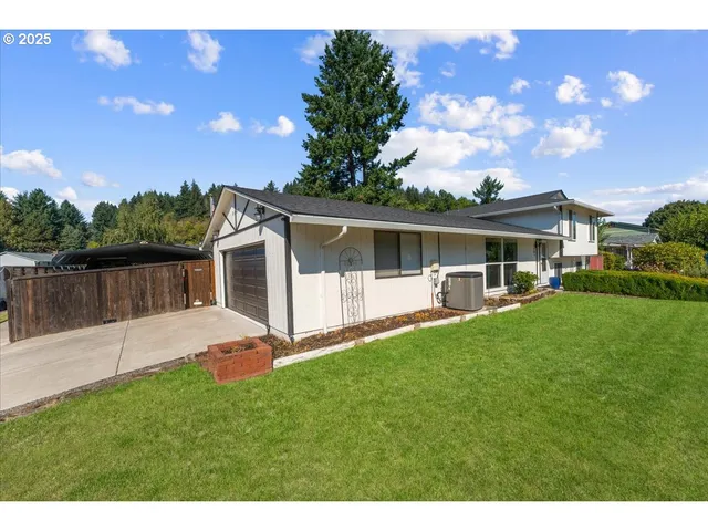 a view of a house with a yard and sitting area
