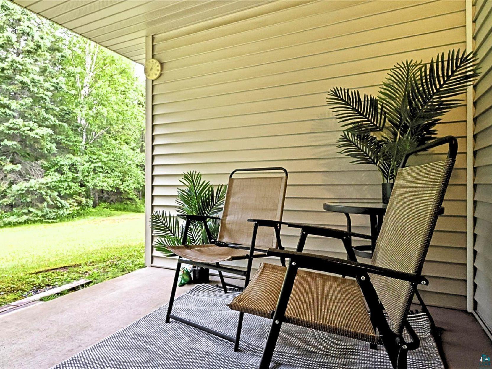 41 East Stark Road Esko, MN 55733 - Photo 16 of 19 Covered patio with neutral siding, concrete flooring, and a striped area rug
