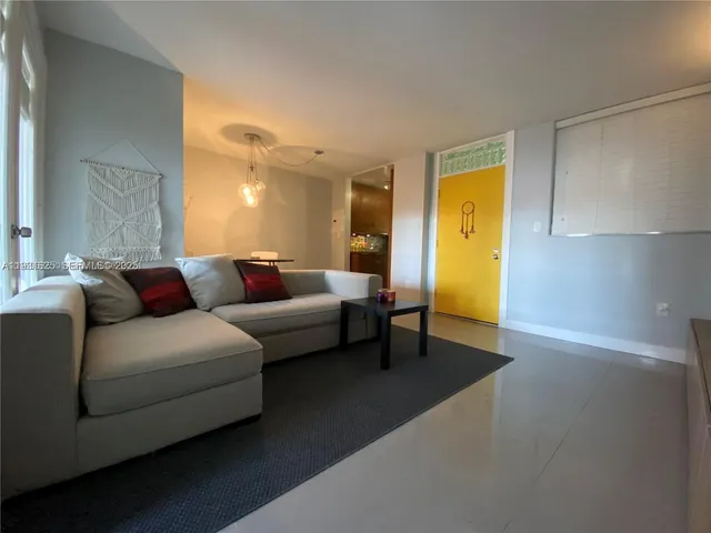 a living room with furniture and a lamp