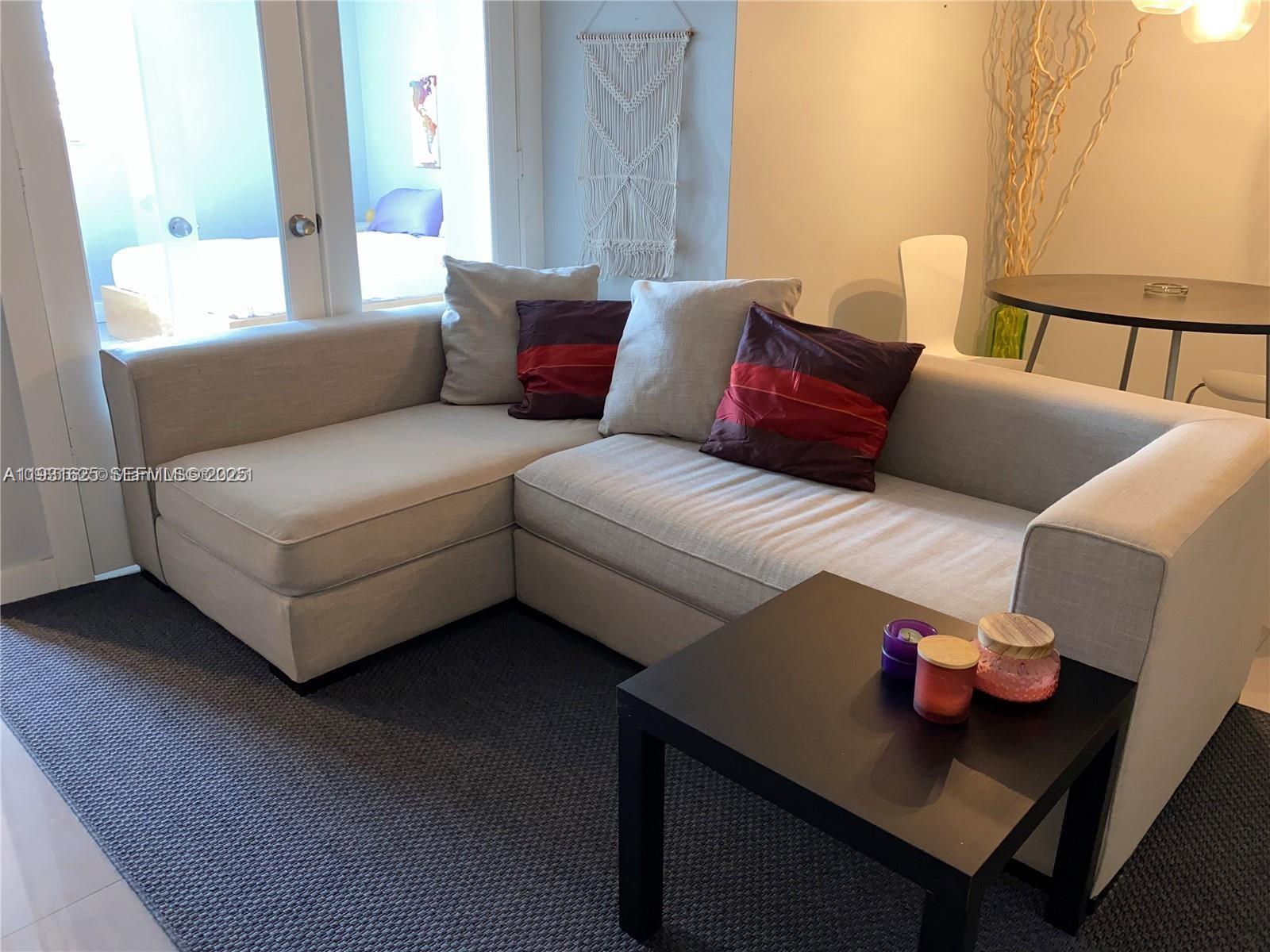 921 Jefferson Avenue, Unit 3B Miami Beach, FL 33139 - Photo 5 of 13 a living room with furniture and a window