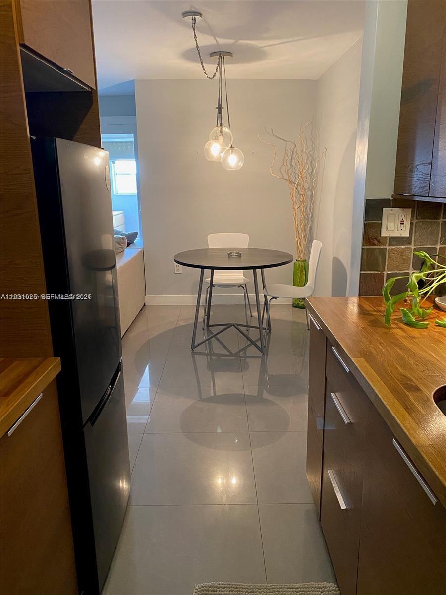921 Jefferson Avenue, Unit 3B Miami Beach, FL 33139 - Photo 6 of 13 a kitchen with stainless steel appliances granite countertop a sink a stove and a refrigerator