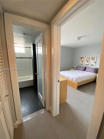 a bedroom with a bed and a walk in closet