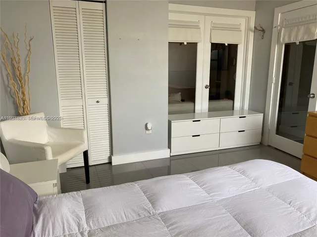 a bedroom with a bed and a mirror