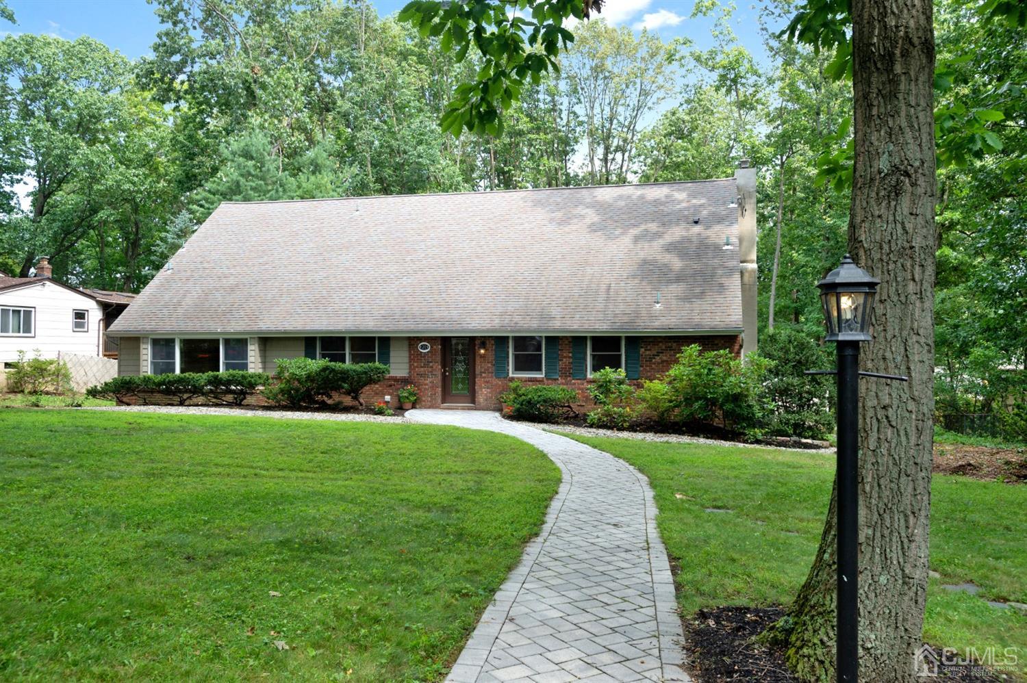 20 Donald Road East Brunswick, NJ 08816 - Photo 2 of 28 a view of a big house with a big yard plants and large trees