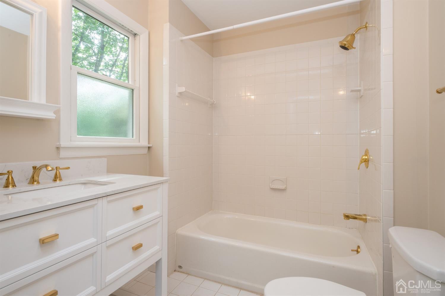 20 Donald Road East Brunswick, NJ 08816 - Photo 18 of 28 a bathroom with a granite countertop tub sink toilet window and mirror