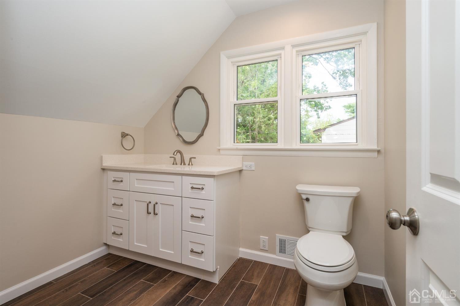 20 Donald Road East Brunswick, NJ 08816 - Photo 21 of 28 a bathroom with a granite countertop toilet a sink and a window