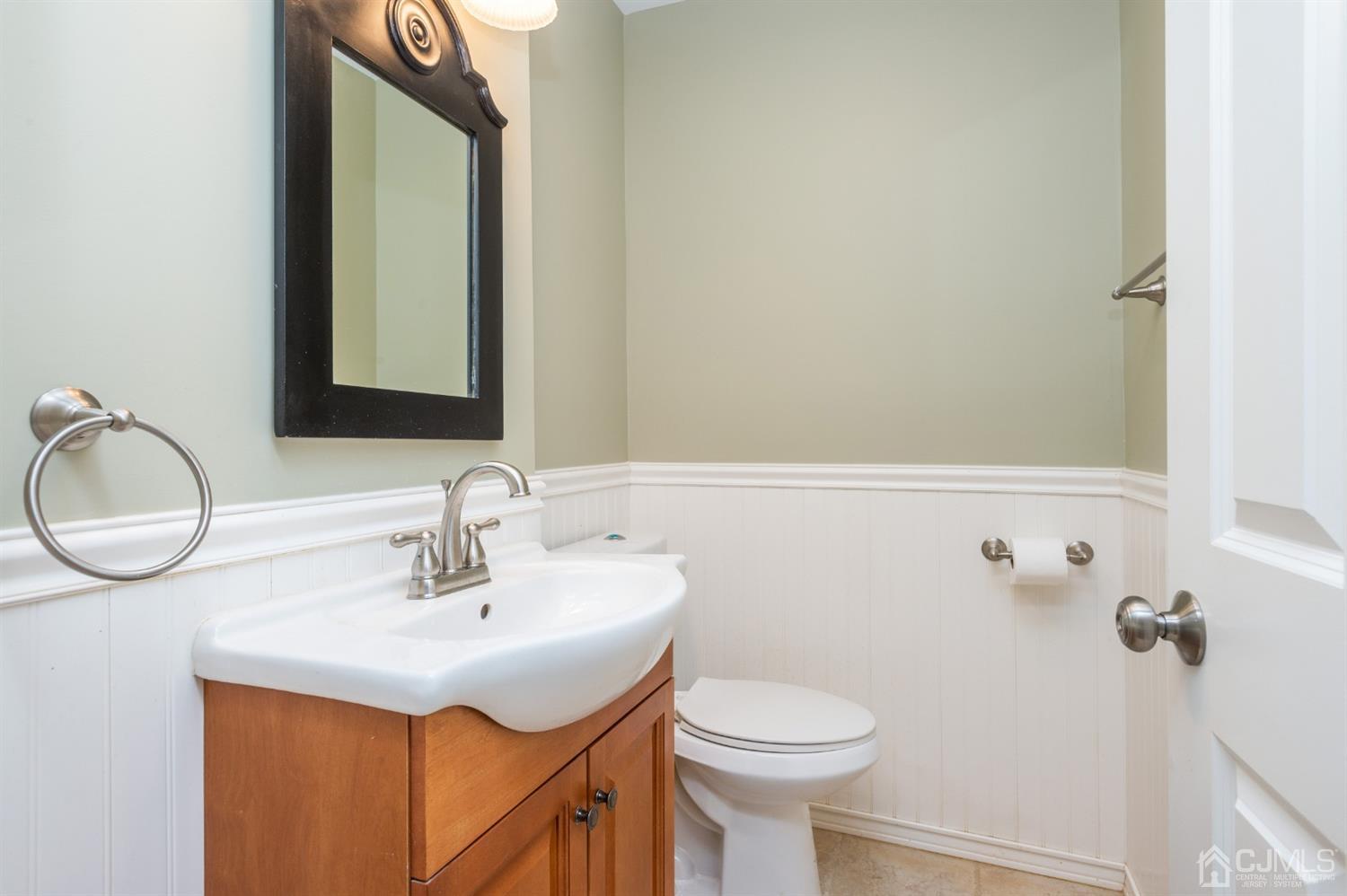 20 Donald Road East Brunswick, NJ 08816 - Photo 24 of 28 a bathroom with a sink a toilet and a mirror