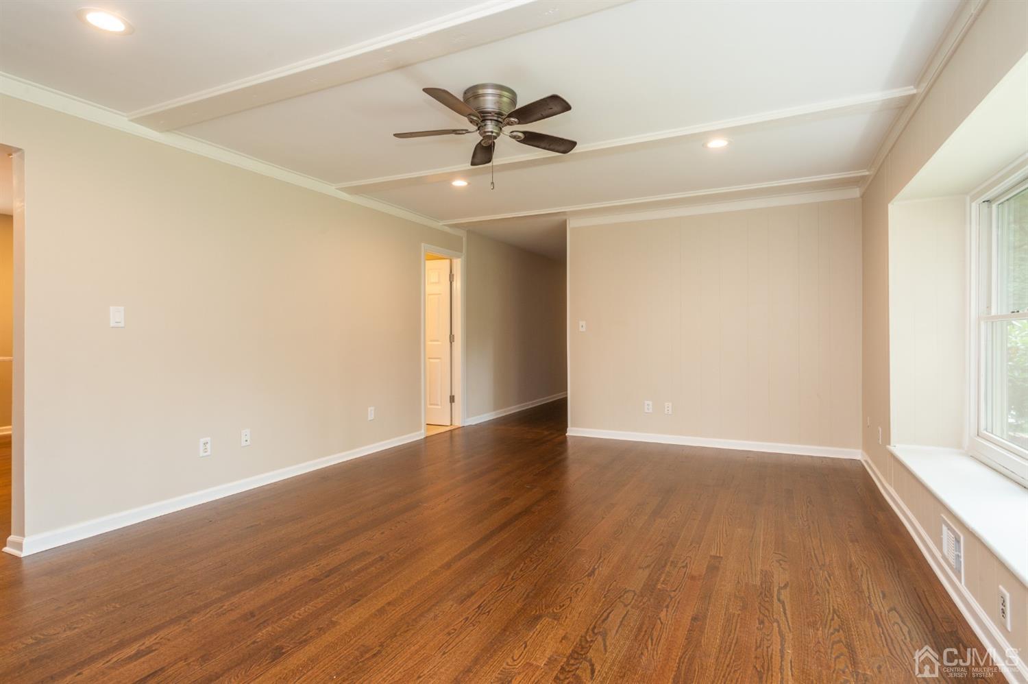 20 Donald Road East Brunswick, NJ 08816 - Photo 4 of 28 an empty room with wooden floor fan and windows