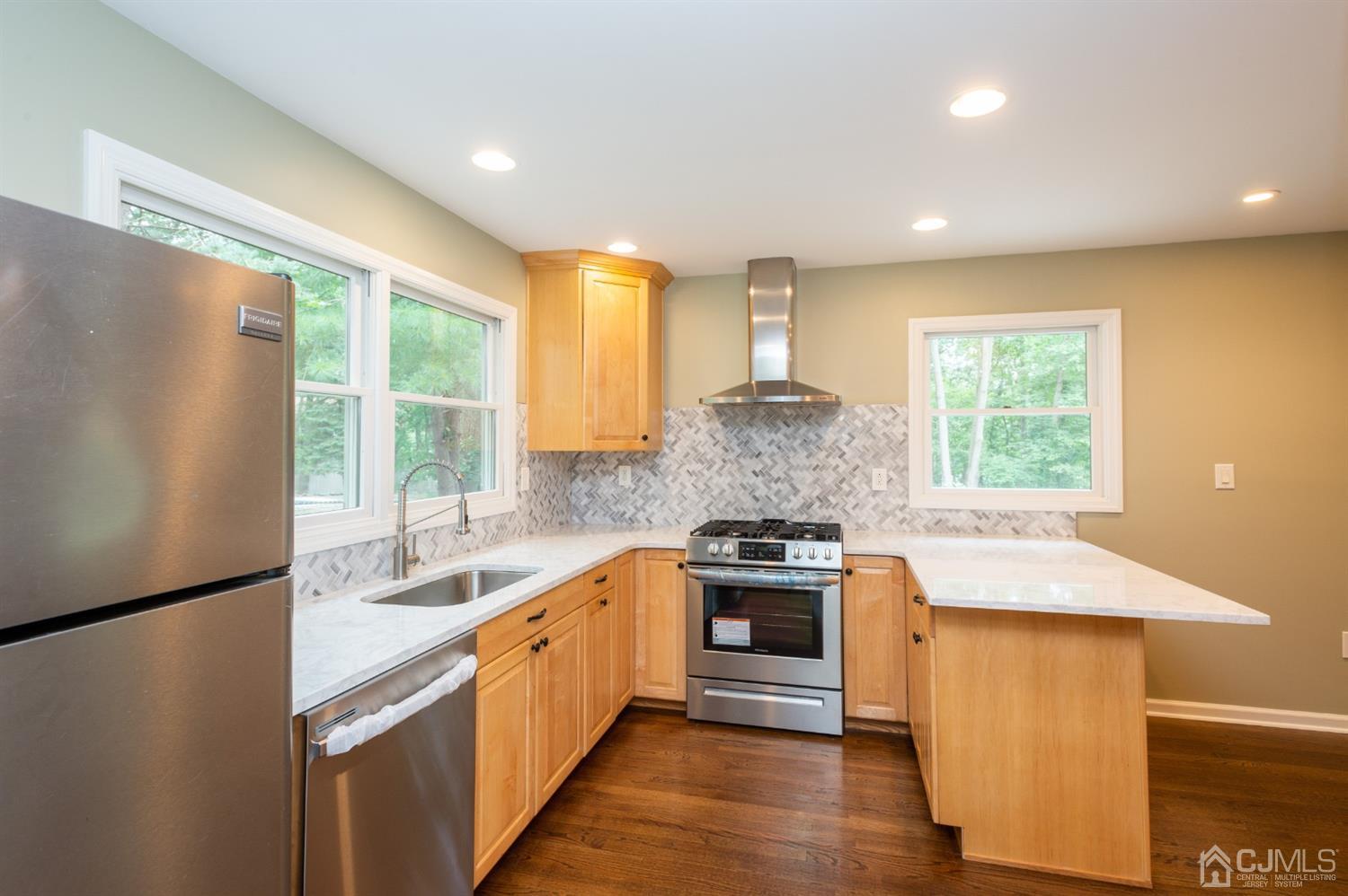 20 Donald Road East Brunswick, NJ 08816 - Photo 8 of 28 a kitchen with stainless steel appliances granite countertop a sink stove and refrigerator