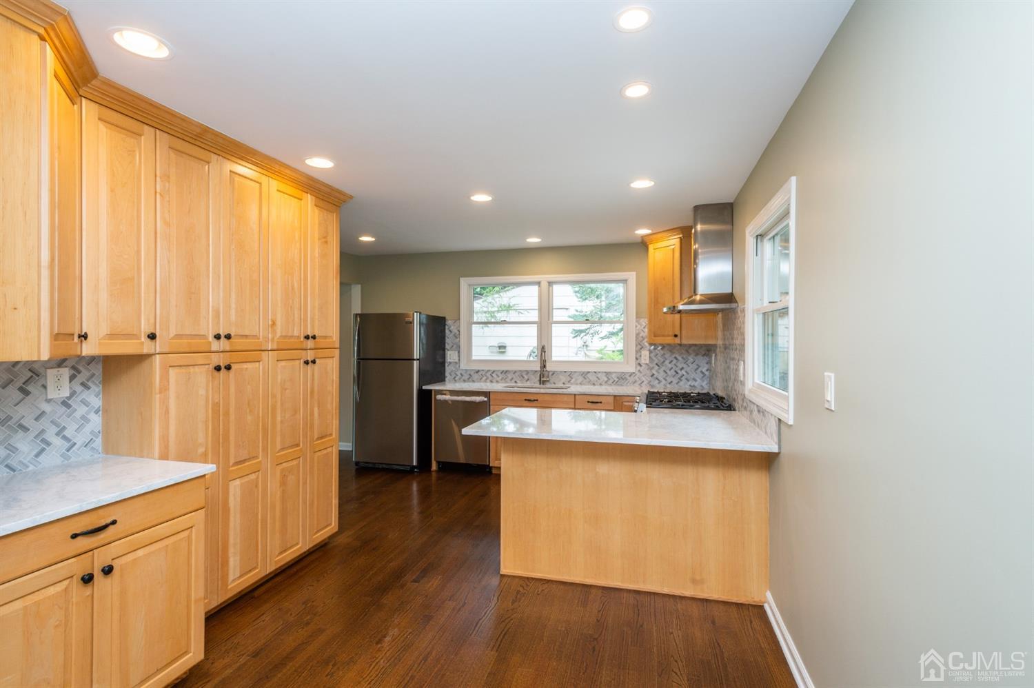 20 Donald Road East Brunswick, NJ 08816 - Photo 9 of 28 a kitchen with kitchen island and wooden floor